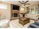 Inviting living room with stone fireplace, large windows, plush seating, and a ceiling fan at 2317 Emerald Woods Dr, Wake Forest, NC 27587