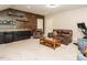 Relaxing living room with rich wood accent wall, comfortable seating, and wet bar for easy entertaining at 2317 Emerald Woods Dr, Wake Forest, NC 27587
