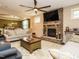 Cozy living room with stone fireplace, a comfortable seating area, and large windows at 2317 Emerald Woods Dr, Wake Forest, NC 27587