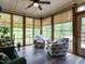 Cozy sunroom with large windows, a ceiling fan, and comfortable seating to enjoy the view at 2317 Emerald Woods Dr, Wake Forest, NC 27587