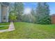 Manicured backyard featuring lawn and mature landscaping at 2418 Mont Haven Dr, Durham, NC 27712