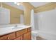 Bathroom with single sink vanity and tub-shower combination, features a mirror and neutral flooring at 2418 Mont Haven Dr, Durham, NC 27712