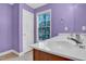 Well-lit bathroom has modern sinks and beautiful purple walls at 2418 Mont Haven Dr, Durham, NC 27712