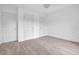 Carpeted bedroom featuring three white doors and neutral walls offering a blank canvas for customization at 2418 Mont Haven Dr, Durham, NC 27712