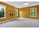 Bright bedroom featuring three windows, a ceiling fan, and pre-installed wall mount for a tv at 2418 Mont Haven Dr, Durham, NC 27712