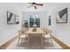 Bright dining room with seating for six, classic decor, and large windows at 2418 Mont Haven Dr, Durham, NC 27712