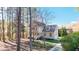 Stunning two-story home with a light exterior, attached garage, and surrounded by beautiful mature trees at 2418 Mont Haven Dr, Durham, NC 27712