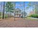 Charming two-story home featuring double balconies, a welcoming red door, and a beautifully landscaped yard at 2418 Mont Haven Dr, Durham, NC 27712