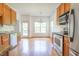 Bright kitchen featuring wood cabinets, stainless steel appliances, and an adjacent dining area with lots of light at 2418 Mont Haven Dr, Durham, NC 27712