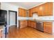 Well-lit kitchen features stainless steel appliances, wood cabinets and hardwood floors at 2418 Mont Haven Dr, Durham, NC 27712