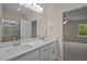 Modern bathroom with double sink vanity and granite countertop, plus tiled shower and linen closet at 25 Leisure Ln # 2, Louisburg, NC 27549