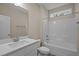 Well-lit bathroom with a single sink vanity and tub-shower combo with white fixtures and decor at 25 Leisure Ln # 2, Louisburg, NC 27549