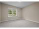 Comfortable bedroom with soft carpeting, a bright window, and ample space for relaxation at 25 Leisure Ln # 2, Louisburg, NC 27549