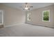 Cozy bedroom featuring soft carpeting, a ceiling fan, and sunny windows for a warm ambiance at 25 Leisure Ln # 2, Louisburg, NC 27549