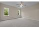 Spacious bedroom with plush carpeting and sun-filled windows overlooking the lush outdoors at 25 Leisure Ln # 2, Louisburg, NC 27549