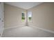 Bright bedroom featuring neutral carpeting and two windows offering ample natural light at 25 Leisure Ln # 2, Louisburg, NC 27549