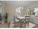 Cozy dining room with a stylish chandelier, wainscoting detail, and ample natural light at 25 Leisure Ln # 2, Louisburg, NC 27549