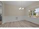 Bright dining room with large window and modern chandelier lighting at 25 Leisure Ln # 2, Louisburg, NC 27549