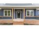 Inviting front porch with brick accents, stylish railings, and a contemporary front door with sidelights at 25 Leisure Ln # 2, Louisburg, NC 27549