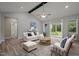Bright living room with vaulted ceiling, ceiling fan, and sliding glass doors to the backyard deck at 25 Leisure Ln # 2, Louisburg, NC 27549