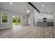 Open-concept space with kitchen, living, and dining areas featuring hardwood floors and abundant natural light at 25 Leisure Ln # 2, Louisburg, NC 27549