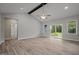 Open living room with vaulted ceilings, fan, and sliding door access to outdoor living at 25 Leisure Ln # 2, Louisburg, NC 27549