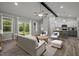 Open-concept living area flows into a modern kitchen with bar seating and access to the backyard deck at 25 Leisure Ln # 2, Louisburg, NC 27549