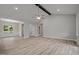Bright open-concept living room showcasing natural light, flooring, and a view into dining room at 25 Leisure Ln # 2, Louisburg, NC 27549
