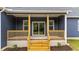 Covered front porch of a home with wooden stairs and rails at 25 Leisure Ln # 2, Louisburg, NC 27549