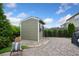 Charming backyard featuring a shed, a stone patio, and lush greenery, perfect for outdoor relaxation at 2709 Sardinia Ln, Apex, NC 27502