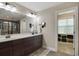 Bathroom boasts double sinks, dark wood cabinets, and a walk-in closet for ample storage at 2709 Sardinia Ln, Apex, NC 27502