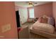 Pink bedroom with a bed, hardwood style floors, a tv, and a double door closet at 2709 Sardinia Ln, Apex, NC 27502