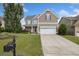 Beautiful two-story home featuring a well-manicured lawn, inviting driveway, and ample curb appeal at 2709 Sardinia Ln, Apex, NC 27502