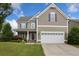 Charming two-story home with a two-car garage, inviting front porch, and well-manicured lawn at 2709 Sardinia Ln, Apex, NC 27502