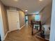 Hallway featuring hardwood style floors, neutral walls, stairs, and a pendant light at 2709 Sardinia Ln, Apex, NC 27502