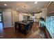 Open kitchen with a center island, stainless steel appliances, and a breakfast table with seating at 2709 Sardinia Ln, Apex, NC 27502