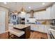 Well-equipped kitchen with stainless steel appliances, white cabinetry, granite countertops, and a central island at 2709 Sardinia Ln, Apex, NC 27502
