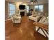 Cozy living room showcasing hardwood floors, fireplace, comfortable seating, and a ceiling fan at 2709 Sardinia Ln, Apex, NC 27502