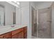 Functional bathroom with wood vanity and glass-enclosed shower stall at 2832 Cameron Pond Dr, Cary, NC 27519
