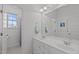 Bright bathroom showcasing a double vanity, large mirror, and neutral tile at 2832 Cameron Pond Dr, Cary, NC 27519