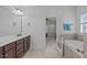 This bathroom boasts a tiled tub, shower, and double vanity, with an attached door that leads to the bedroom at 2832 Cameron Pond Dr, Cary, NC 27519