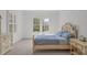 Sunlit bedroom boasting a decorative bed frame, soft blue bedding, and shuttered windows at 2832 Cameron Pond Dr, Cary, NC 27519