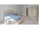 Cozy bedroom featuring blue bedding, a carved bed frame, and ample storage at 2832 Cameron Pond Dr, Cary, NC 27519