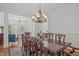 Spacious dining room with hardwood floors, a chandelier, and ample seating around a wooden table at 2832 Cameron Pond Dr, Cary, NC 27519
