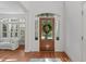 Bright foyer showcasing hardwood floors, a wooden door with sidelights, and elegant white trim at 2832 Cameron Pond Dr, Cary, NC 27519