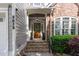 Inviting front porch with stone steps, a wood door, and tasteful landscaping at 2832 Cameron Pond Dr, Cary, NC 27519