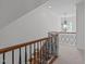 Upstairs hallway with carpet and iron handrails next to a bright window at 2832 Cameron Pond Dr, Cary, NC 27519