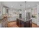 Open kitchen with an island, granite countertops, and stainless steel appliances at 2832 Cameron Pond Dr, Cary, NC 27519