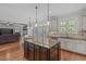 Open concept kitchen and living room space offers an island and natural light at 2832 Cameron Pond Dr, Cary, NC 27519