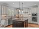 Gourmet kitchen featuring granite countertops, custom cabinets, and stainless steel appliances at 2832 Cameron Pond Dr, Cary, NC 27519